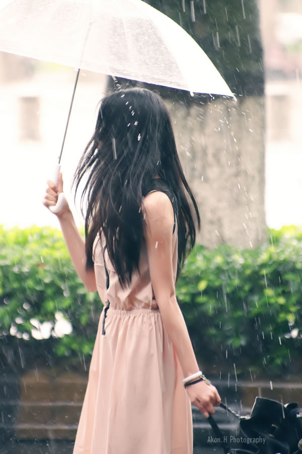 下雨了 女孩撑伞走过的图片